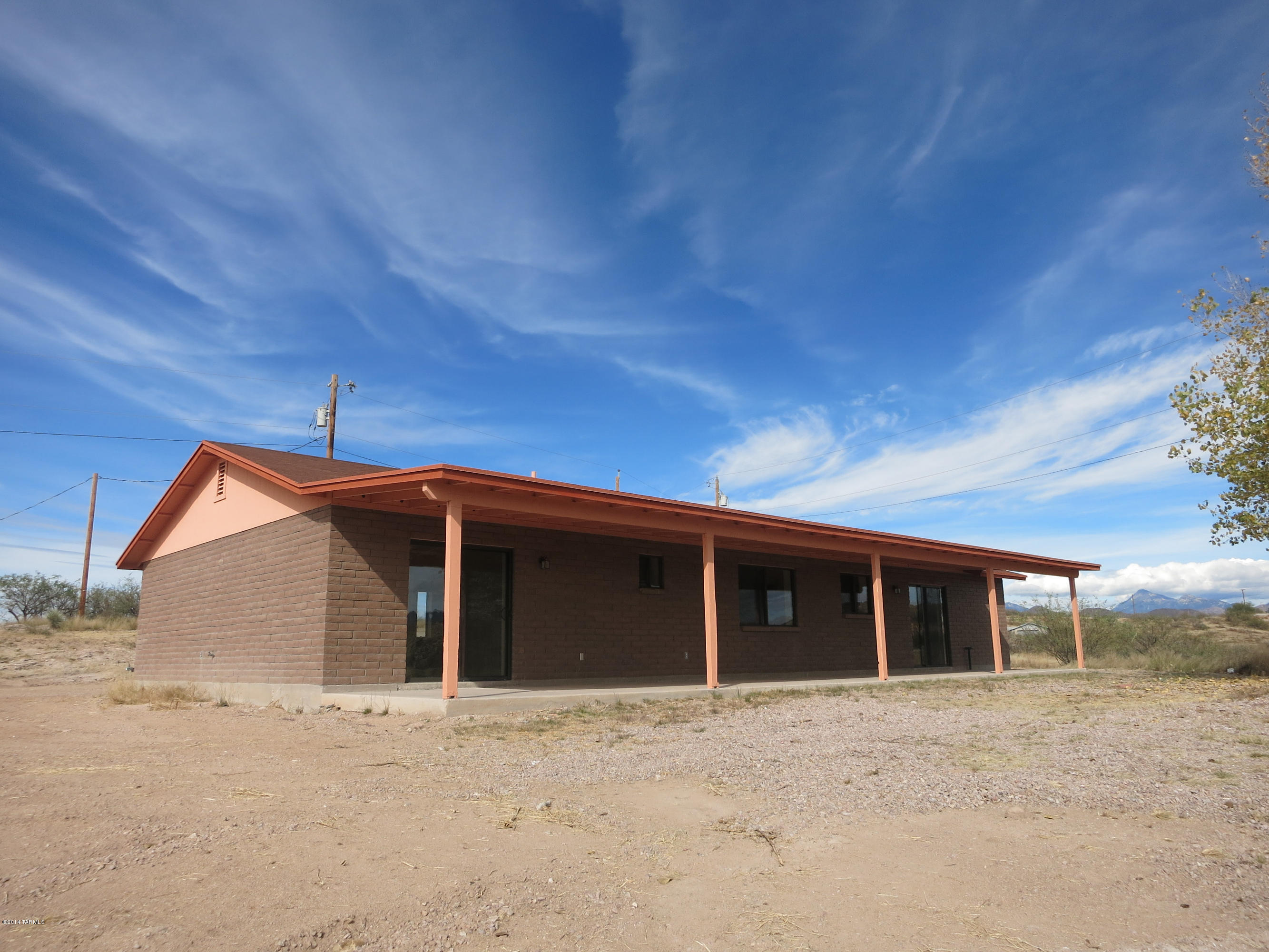 1055 Ameca Court Rio Rico, AZ 85648 - Photo 2 of 18 a view of a house with a yard and garage