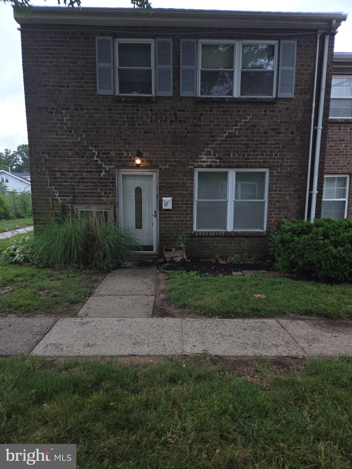 12135 Academy Road, Unit 52 Philadelphia, PA 19154 - Photo 1 of 1 Charming brick facade with lush greenery.
