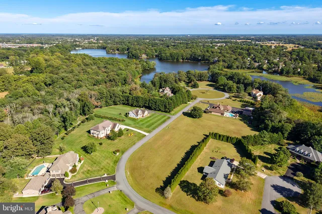 an aerial view of a house with a lake view