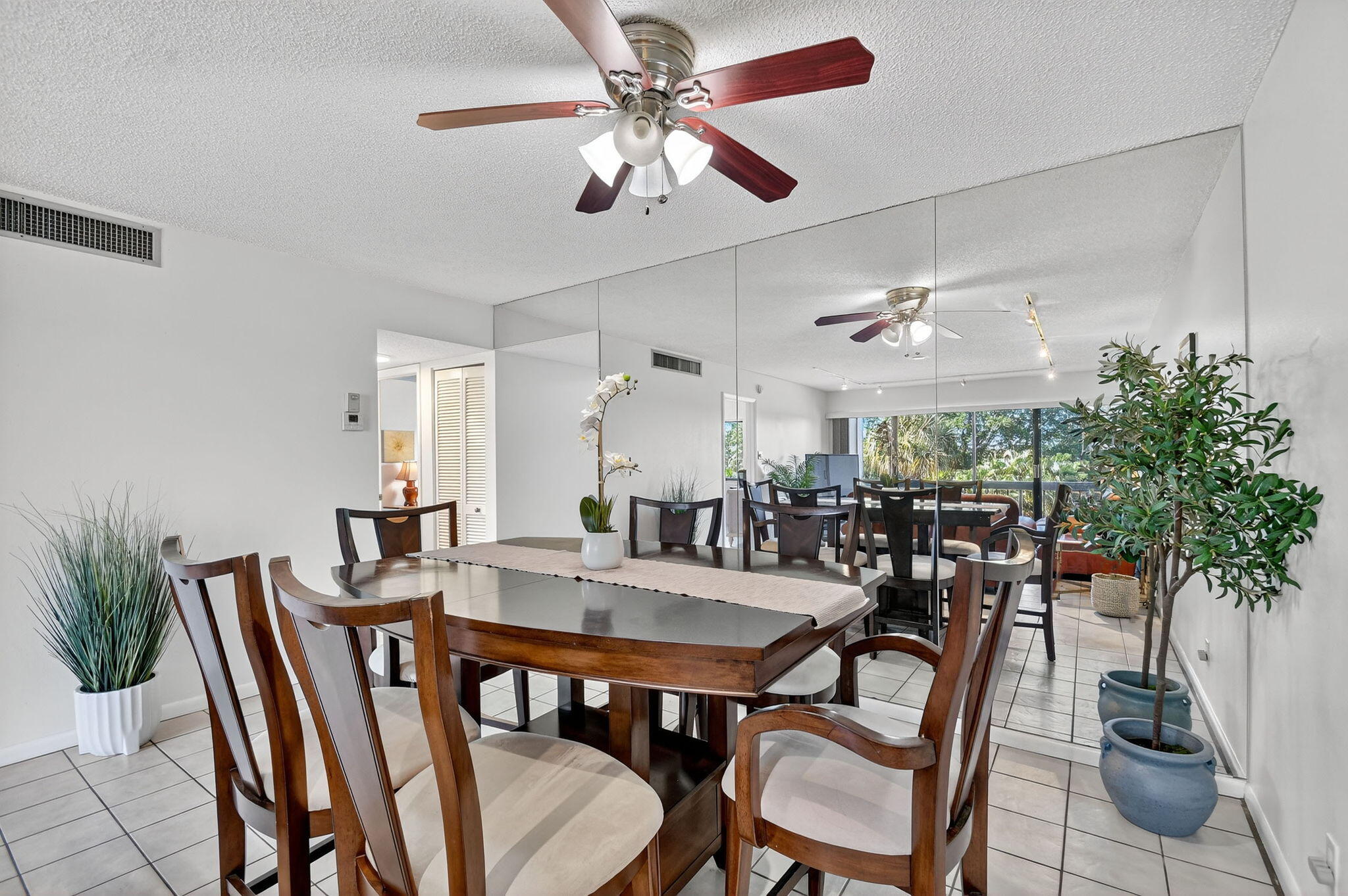 2500 Presidential Way, Unit 302 West Palm Beach, FL 33401 - Photo 13 of 52 a view of a dining room with furniture window and wooden floor