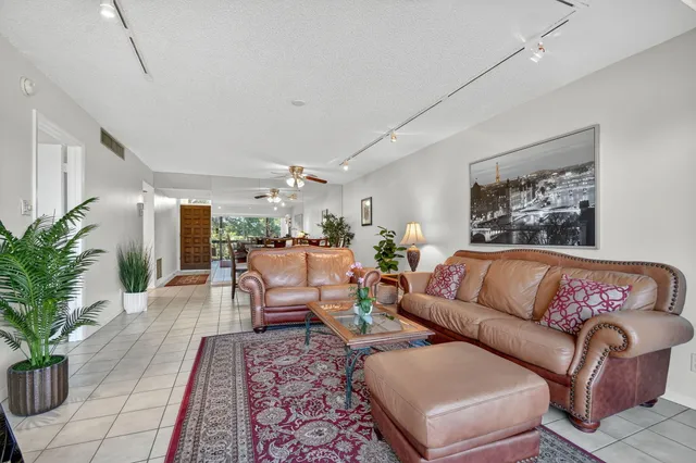 a living room with furniture or couch and a potted plant