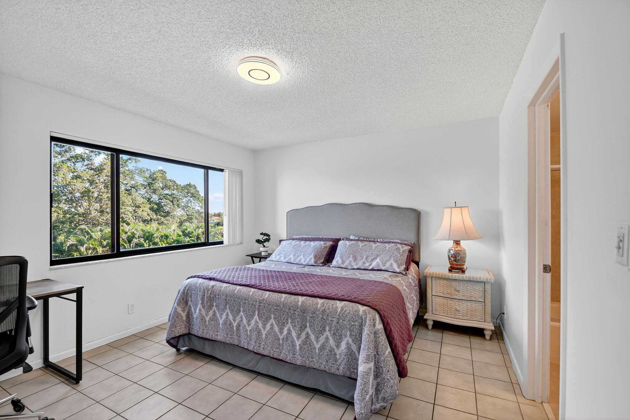 2500 Presidential Way, Unit 302 West Palm Beach, FL 33401 - Photo 23 of 52 a bedroom with a large bed and a window