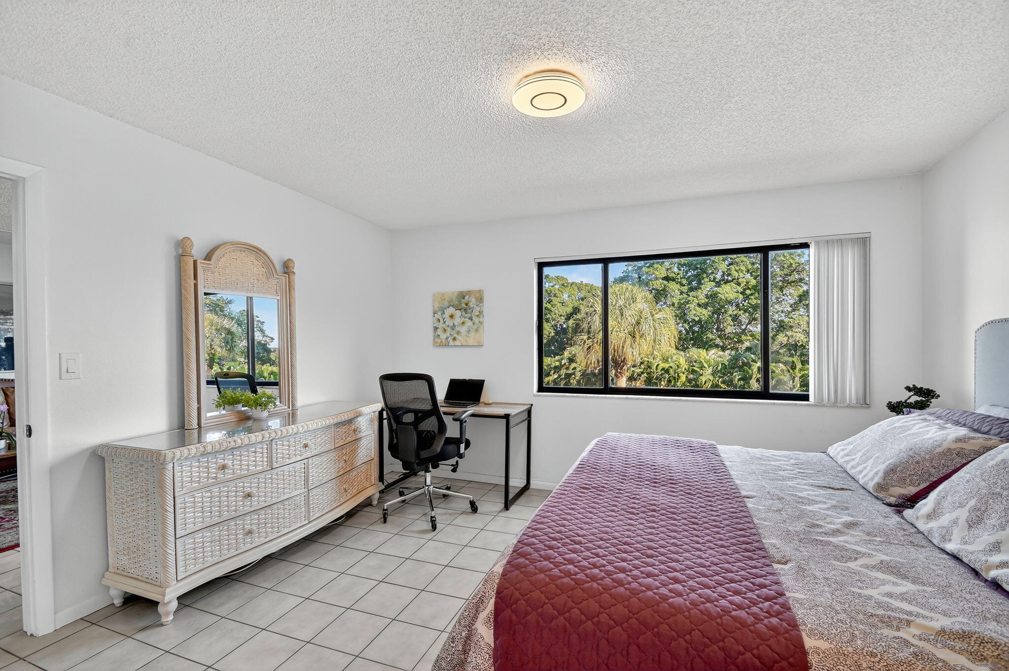 2500 Presidential Way, Unit 302 West Palm Beach, FL 33401 - Photo 25 of 52 a bed room with a bed and a chair