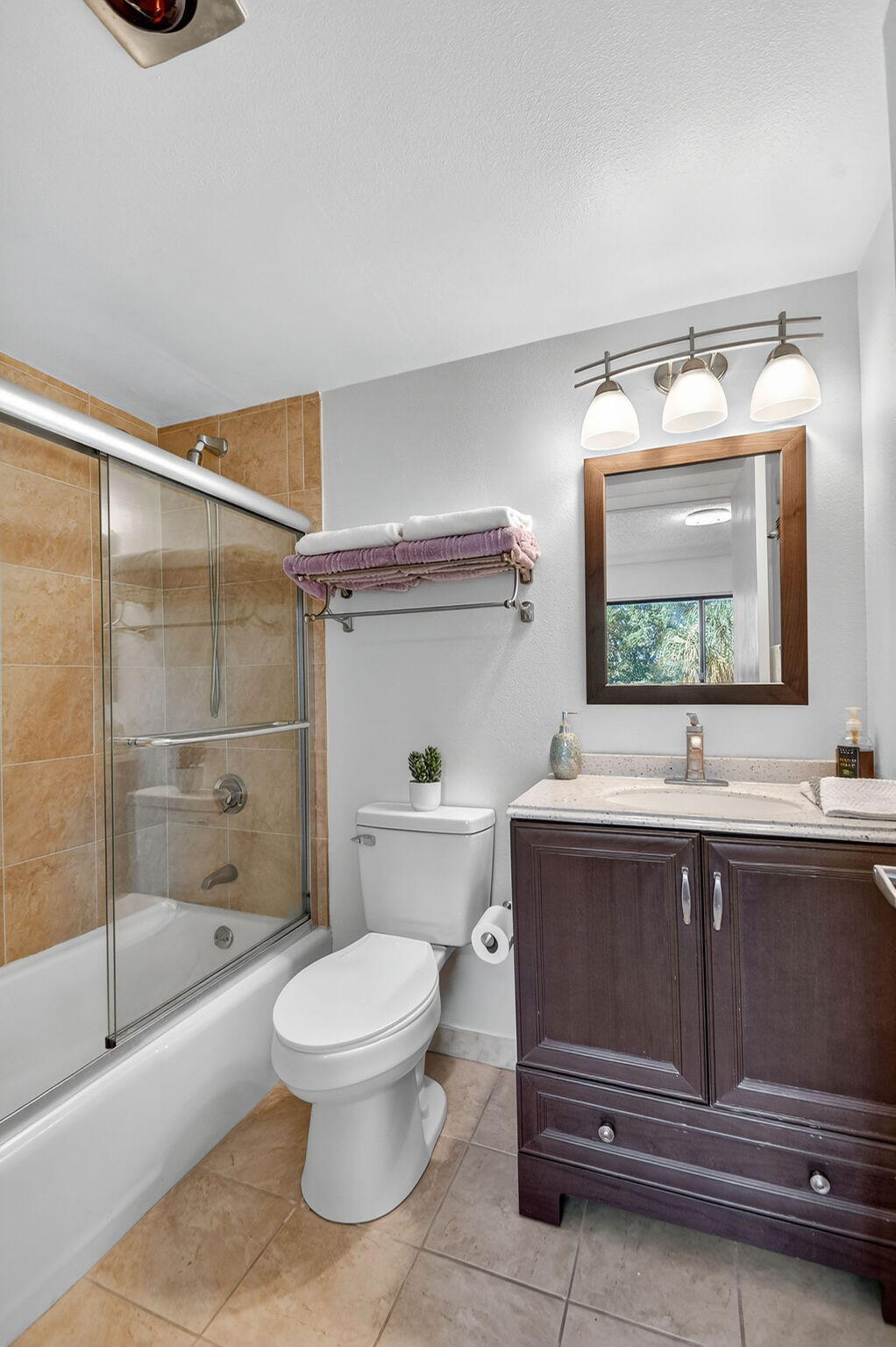 2500 Presidential Way, Unit 302 West Palm Beach, FL 33401 - Photo 28 of 52 a bathroom with a sink a toilet and shower