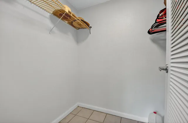 a bedroom with two beds and potted plant
