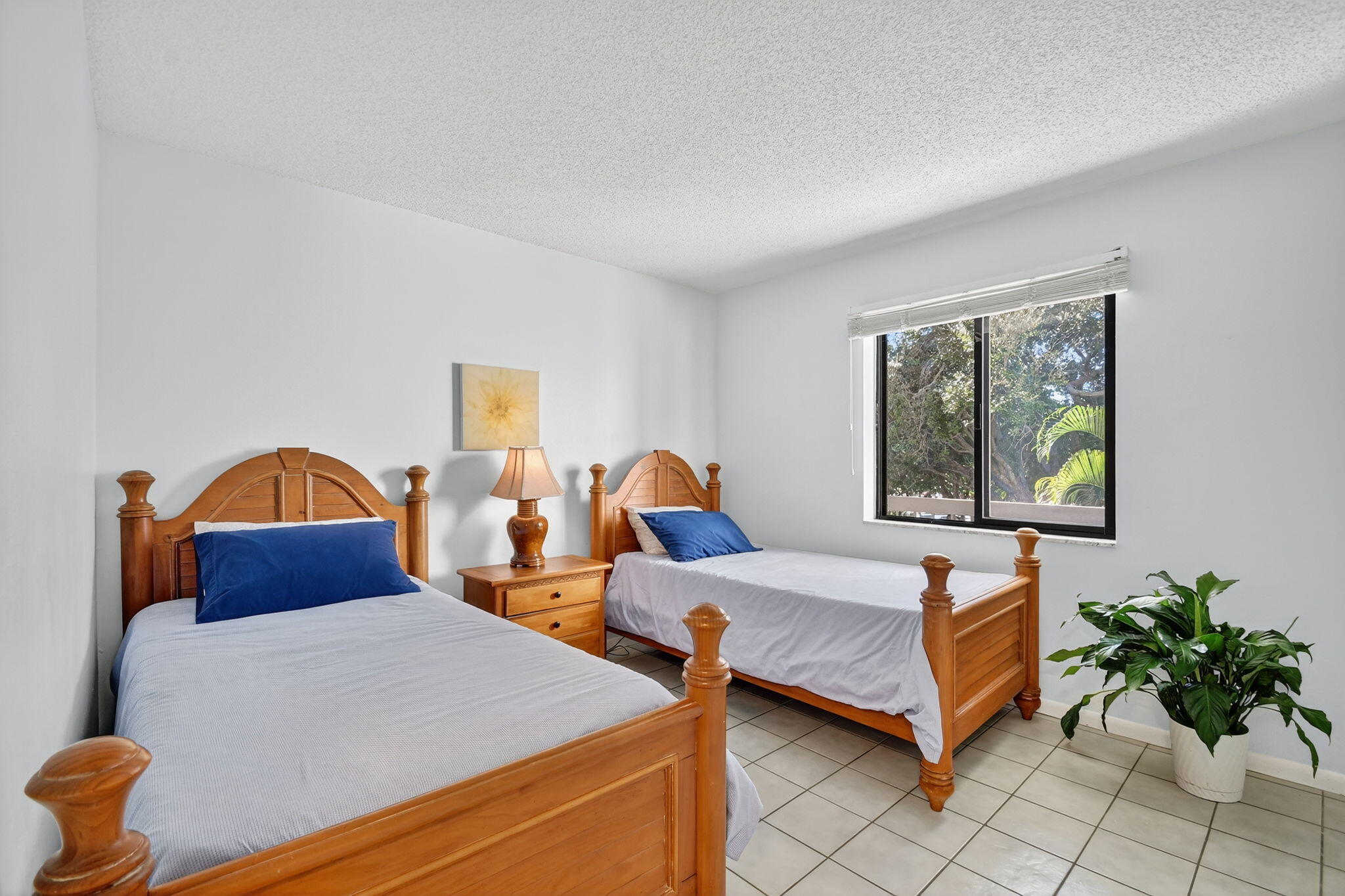 2500 Presidential Way, Unit 302 West Palm Beach, FL 33401 - Photo 30 of 52 a bedroom with two beds and potted plant