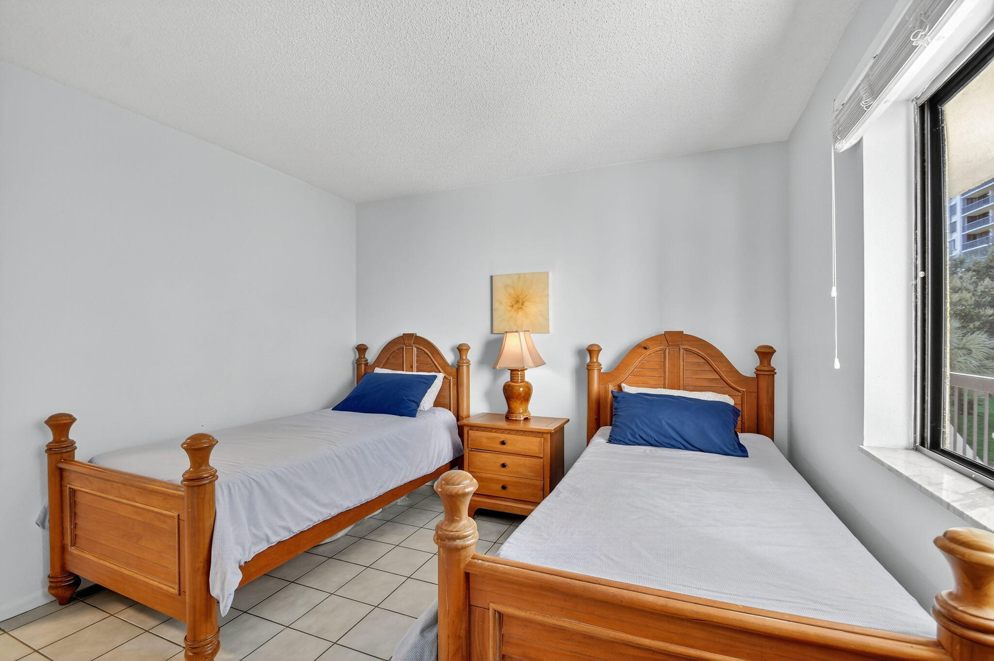 2500 Presidential Way, Unit 302 West Palm Beach, FL 33401 - Photo 31 of 52 a bedroom with two beds and window