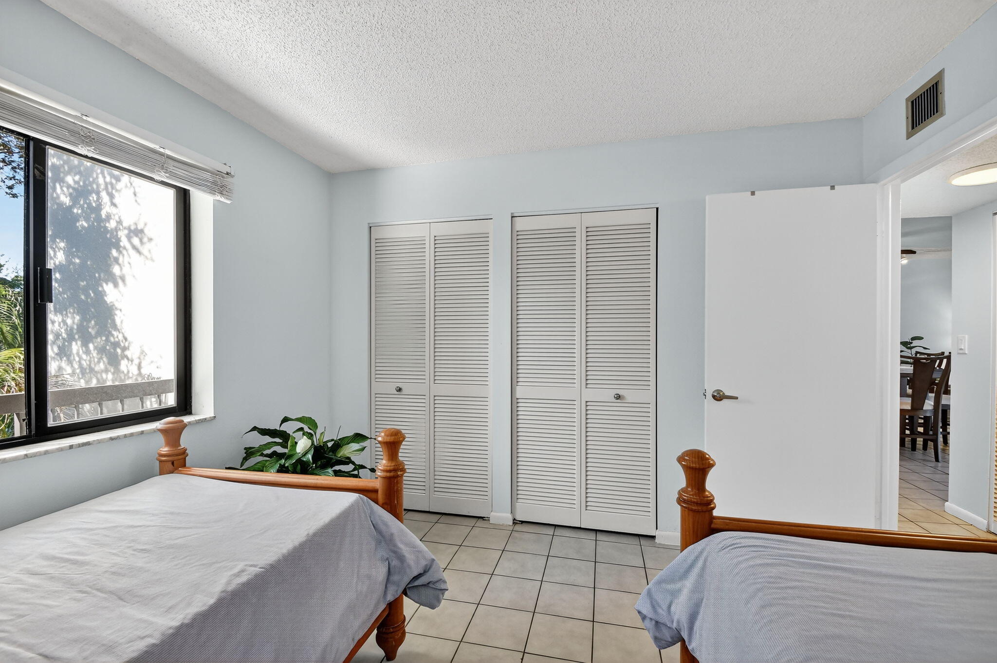 2500 Presidential Way, Unit 302 West Palm Beach, FL 33401 - Photo 32 of 52 a bedroom with a bed and a window