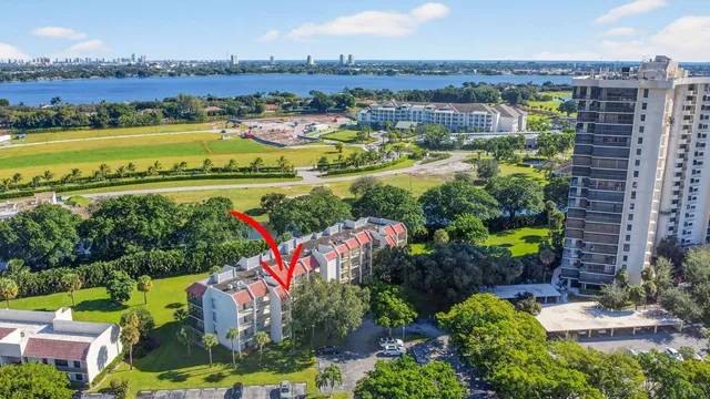 a aerial view of multi story residential apartment building with a yard