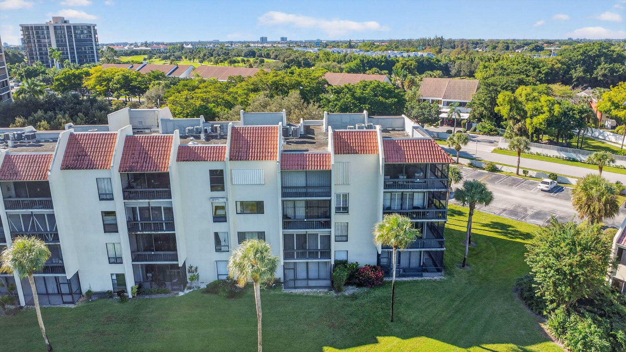 2500 Presidential Way, Unit 302 West Palm Beach, FL 33401 - Photo 49 of 52 a aerial view of multi story residential apartment building with a yard