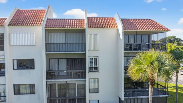an aerial view of a house with a yard and swimming pool