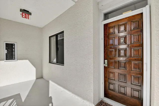 a hallway with a large window and a book shelf