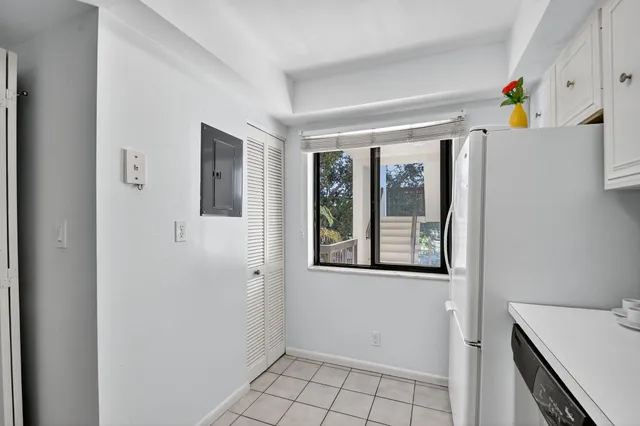 a view of an entryway with wooden floor and cabinet