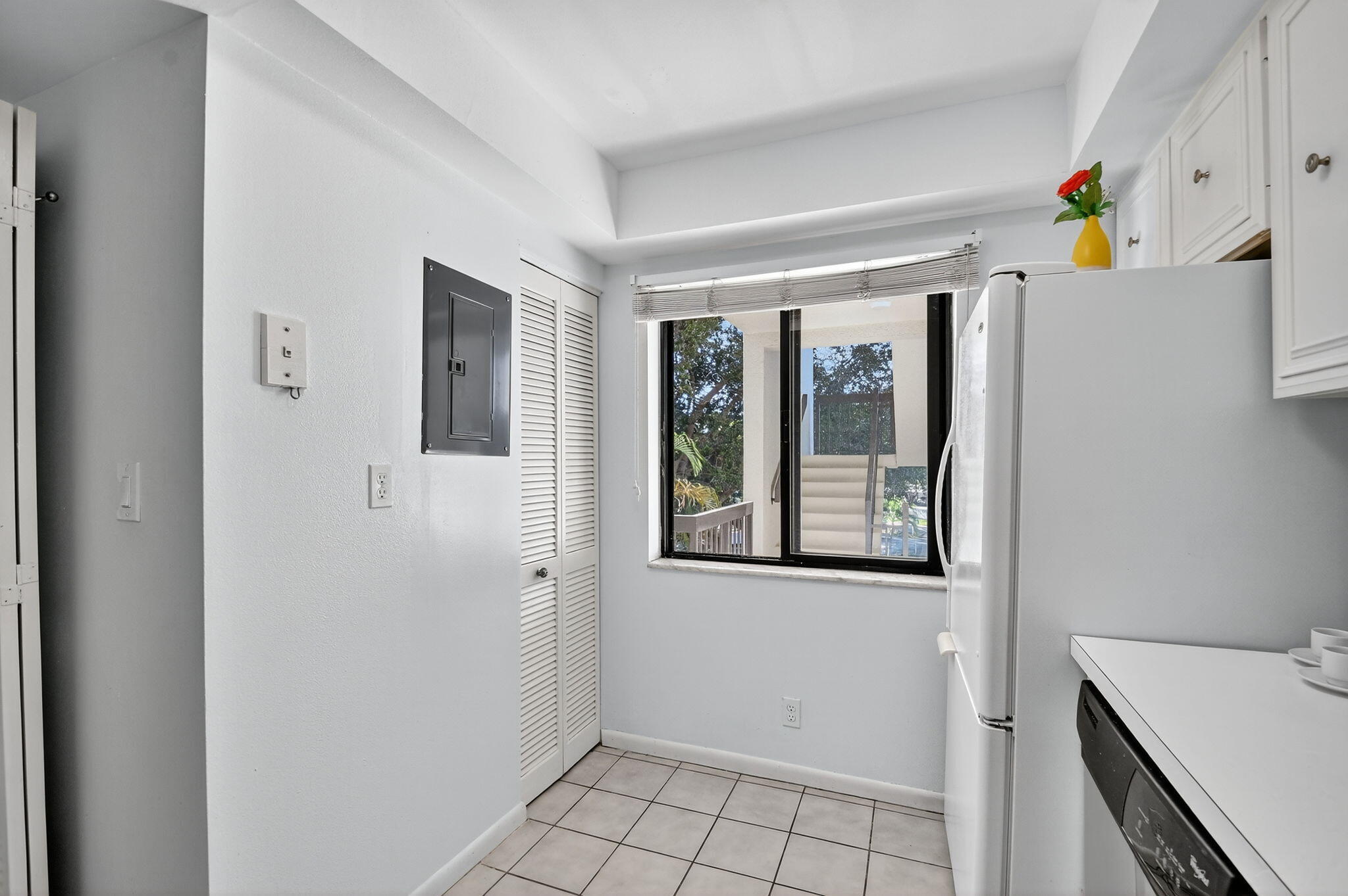 2500 Presidential Way, Unit 302 West Palm Beach, FL 33401 - Photo 8 of 52 a view of an entryway with wooden floor and cabinet