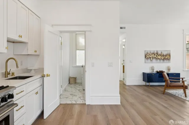 a spacious bathroom with a granite countertop sink a mirror and a toilet