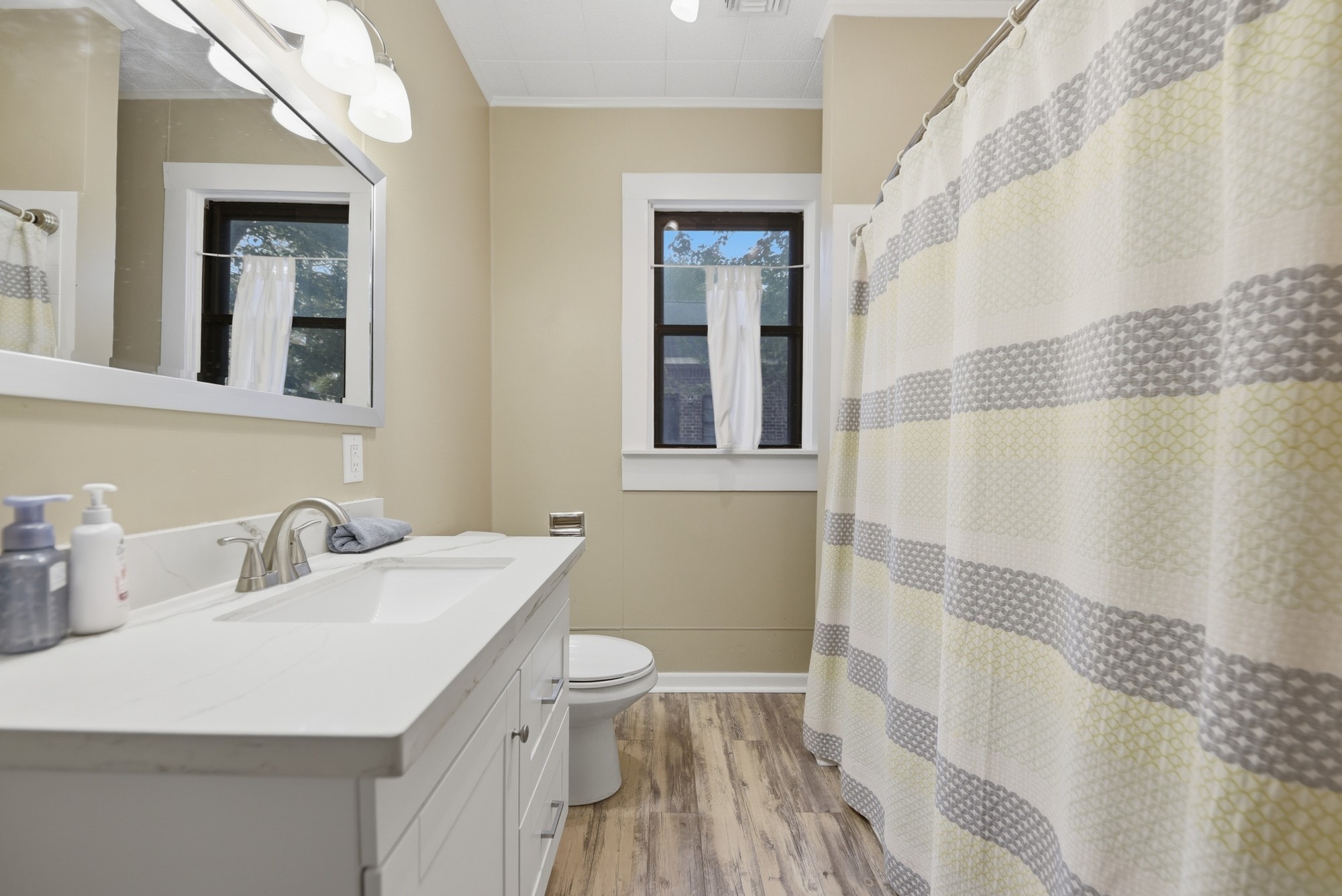 1501 South Austin Street Brenham, TX 77833 - Photo 22 of 36 a bathroom with a sink a toilet and shower