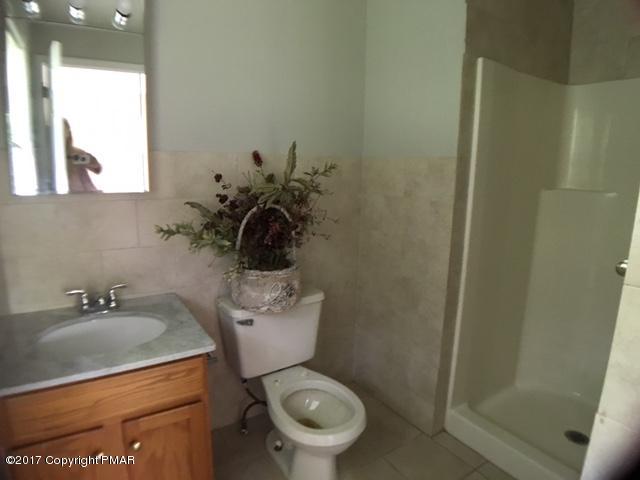 137 Ryan Road Blakeslee, PA 18610 - Photo 10 of 13 a bathroom with a toilet sink and mirror