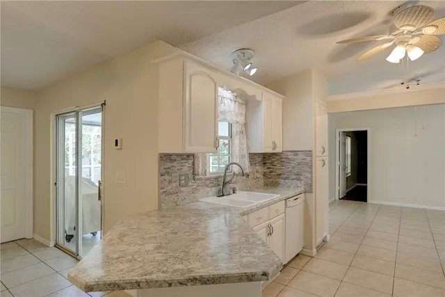 a bathroom with a granite countertop sink a mirror and a shower