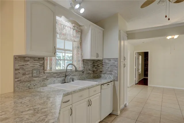 a kitchen with sink cabinets and window