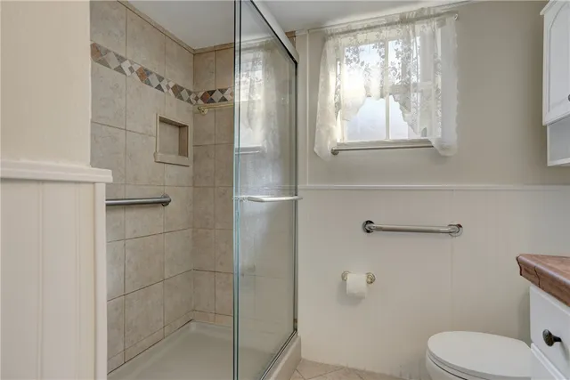 a bathroom with a toilet and a shower