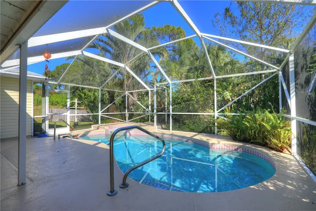 a view of a backyard with swimming pool
