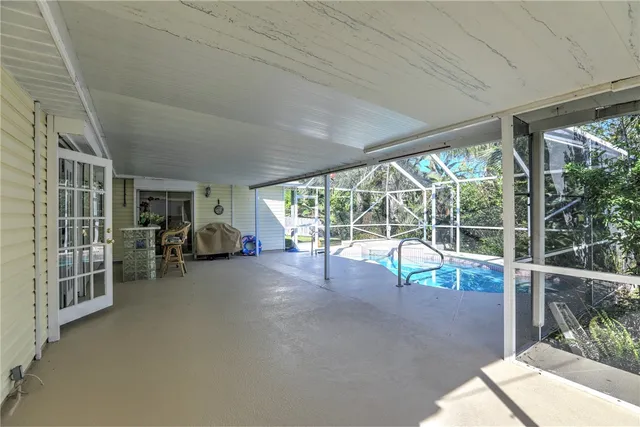 a view of a porch with furniture and floor to ceiling window