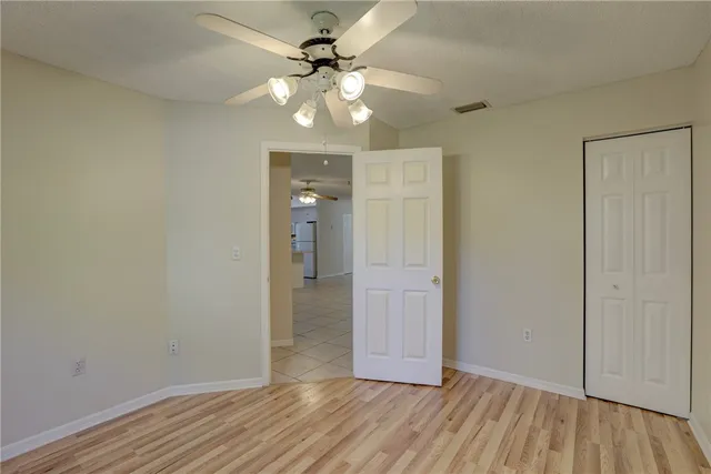 wooden floor in an empty room with a mirror