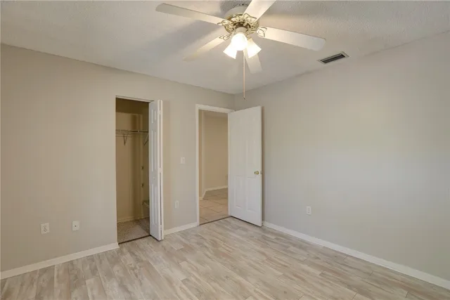 a view of an empty room with a fan