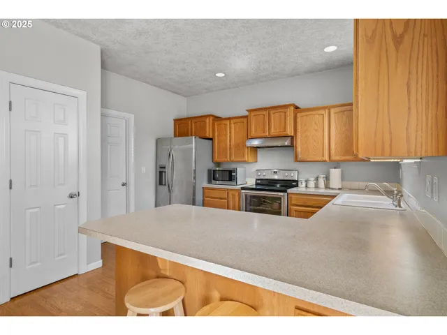 a kitchen with stainless steel appliances granite countertop a refrigerator sink and cabinets