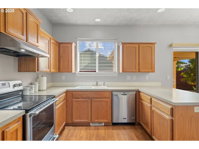 a kitchen with a sink stove and cabinets