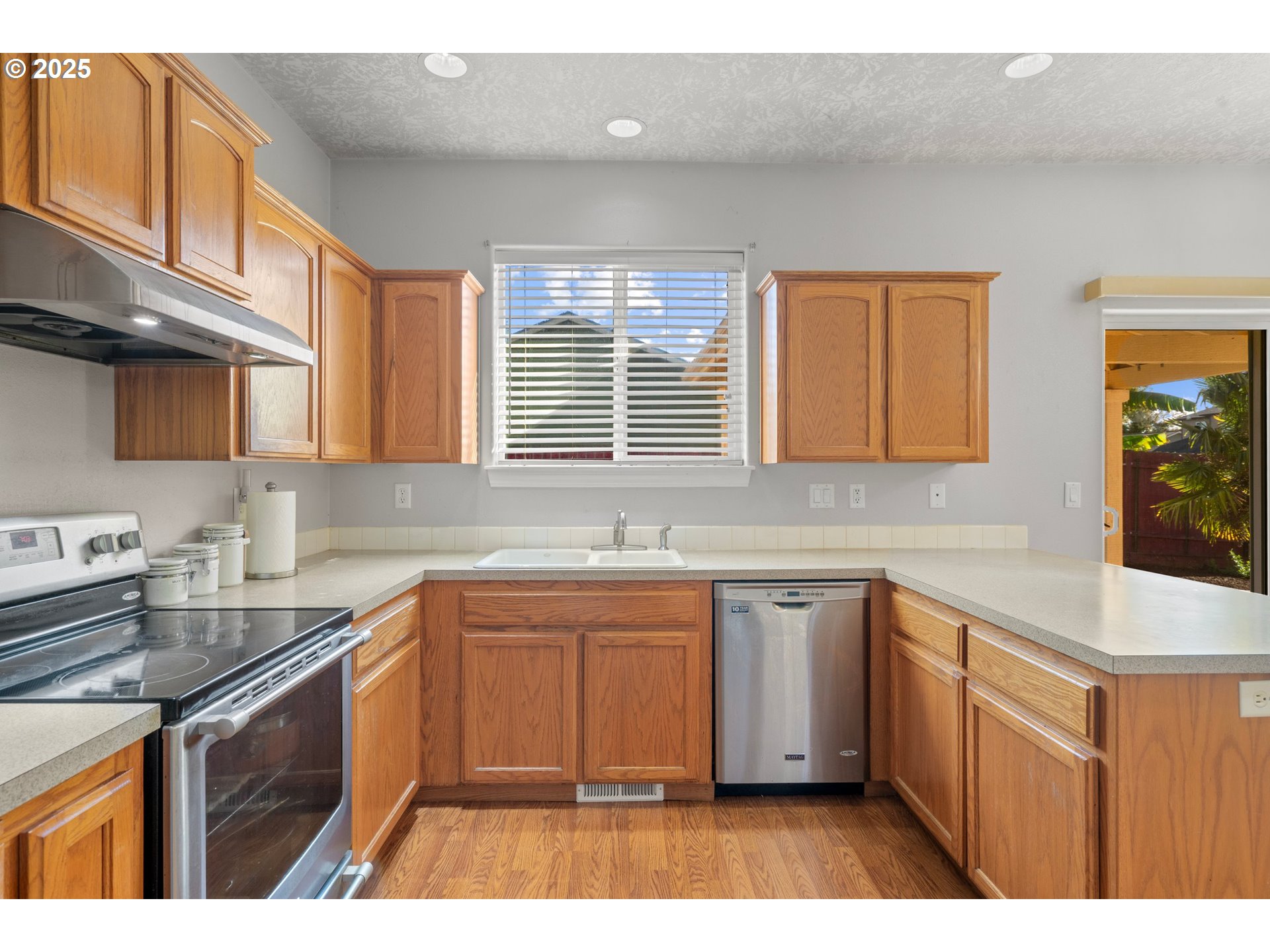4199 Geranium Loop Northeast Salem, OR 97305 - Photo 14 of 43 a kitchen with a sink stove and cabinets