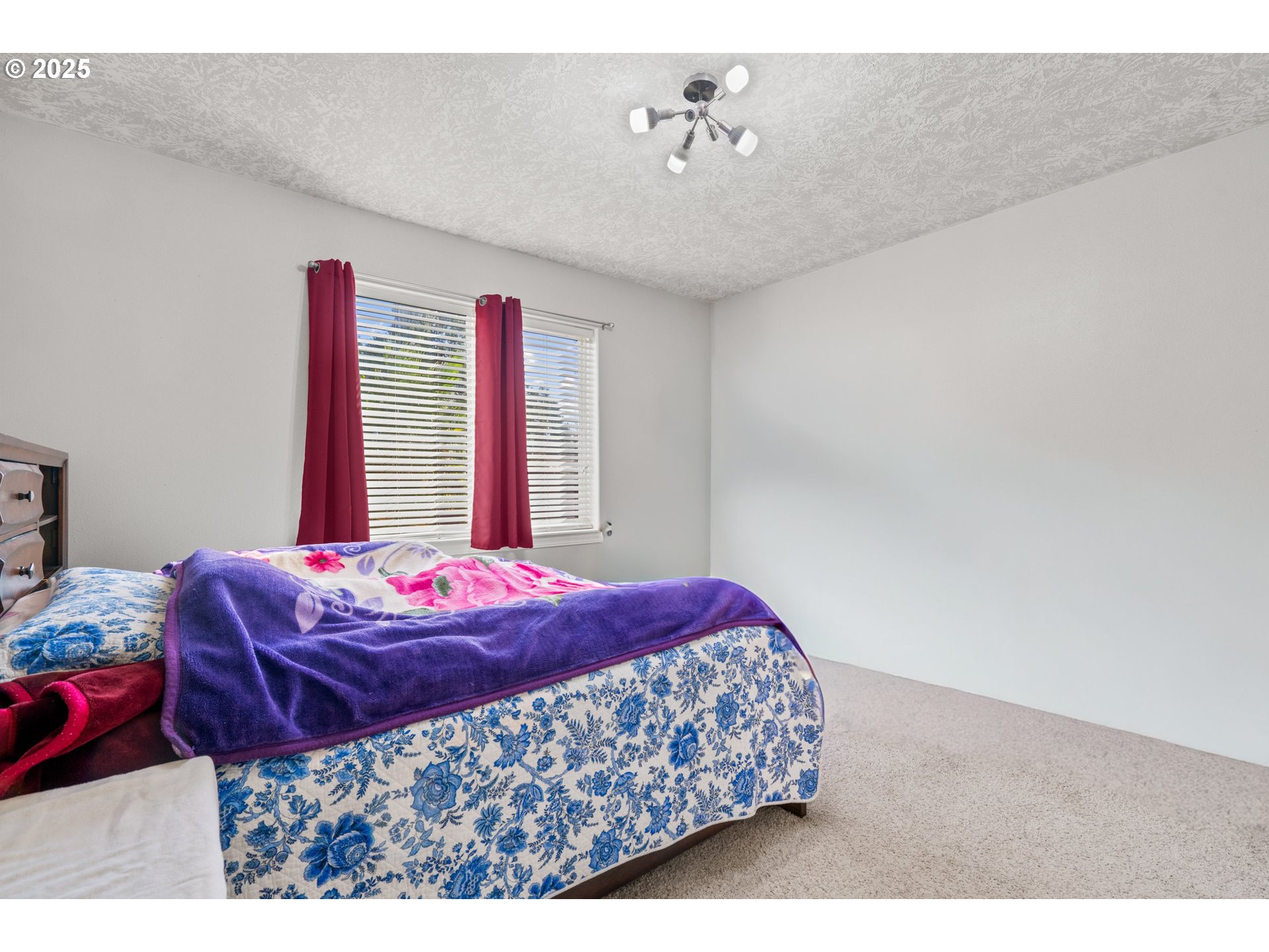 4199 Geranium Loop Northeast Salem, OR 97305 - Photo 16 of 43 a bedroom with a bed and a chandelier
