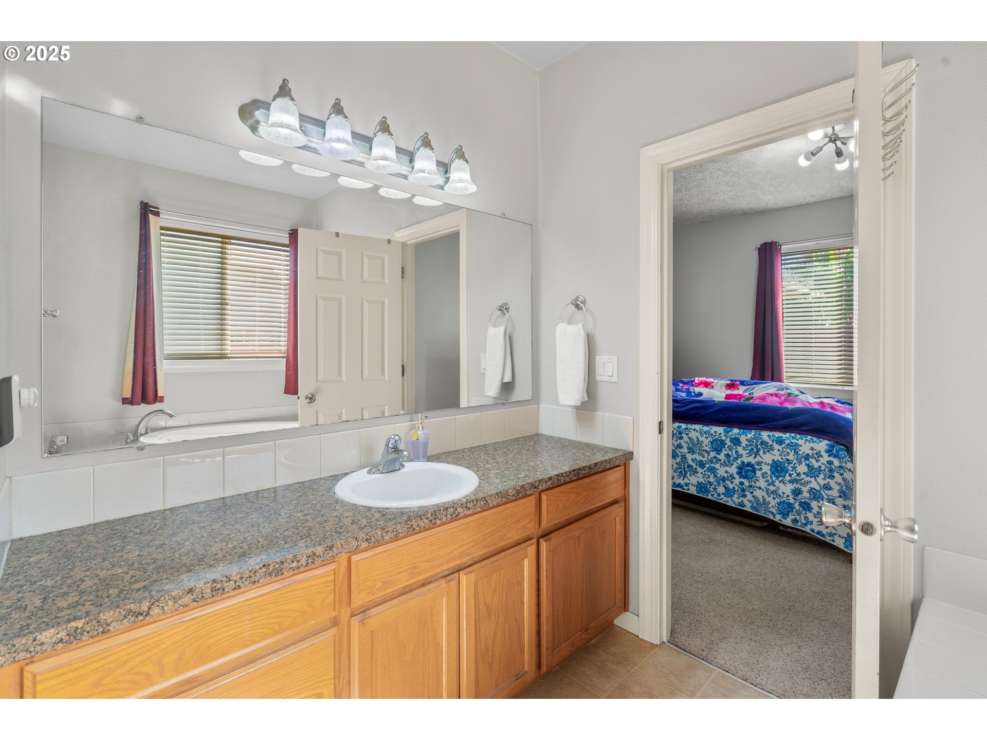 4199 Geranium Loop Northeast Salem, OR 97305 - Photo 18 of 43 a bathroom with a granite countertop sink a mirror and shower