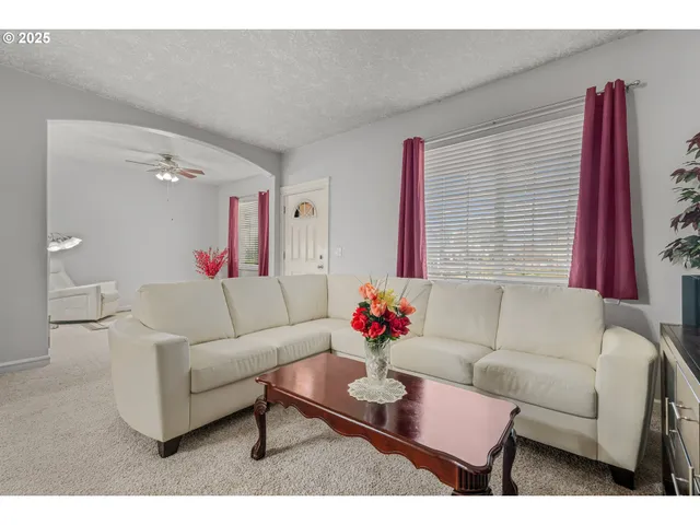 a living room with furniture and a potted plant