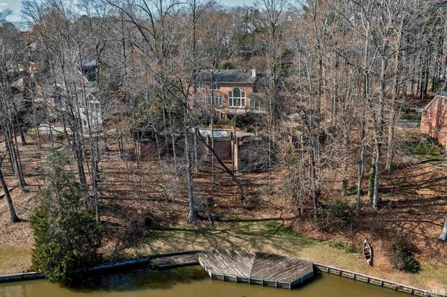 an aerial view of residential house with outdoor space and lake view