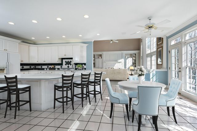 a kitchen with stainless steel appliances kitchen island granite countertop a sink and cabinets
