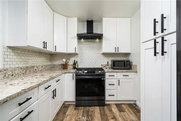a kitchen with stainless steel appliances granite countertop a stove and a refrigerator