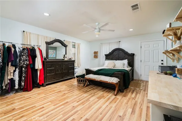 a bedroom with furniture and a wooden floor
