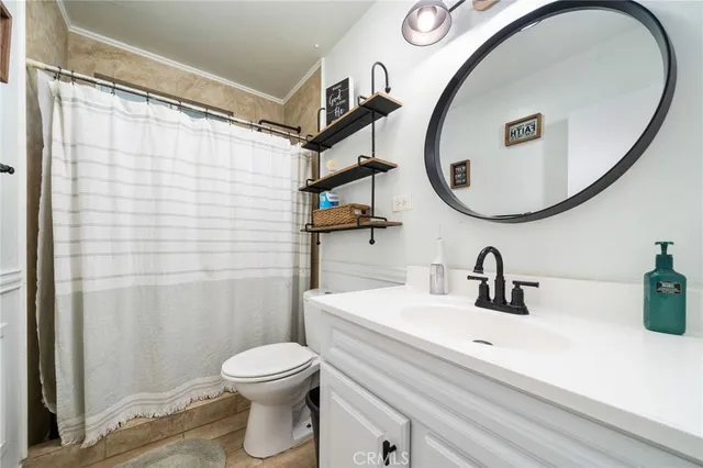 a bathroom with a sink a mirror a toilet and a mirror