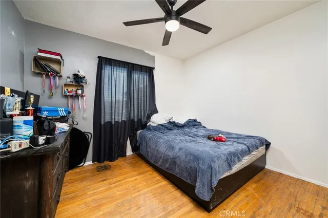 a bed sitting in a bedroom next to a window