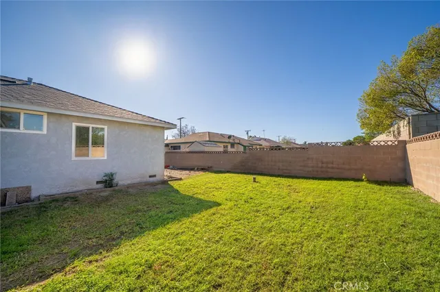 a backyard of a house with lots of green space and mountain view in back