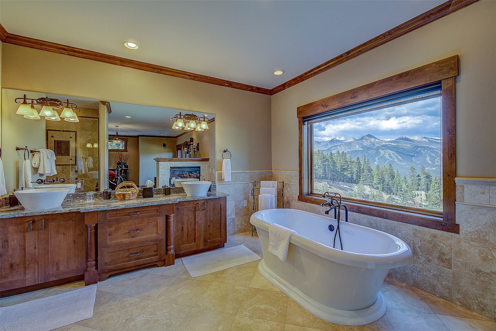 59 Club House Road, Unit C Breckenridge, CO 80424 - Photo 20 of 50 Full bath featuring tile walls, a freestanding tub, double vanity, wainscoting, and crown molding