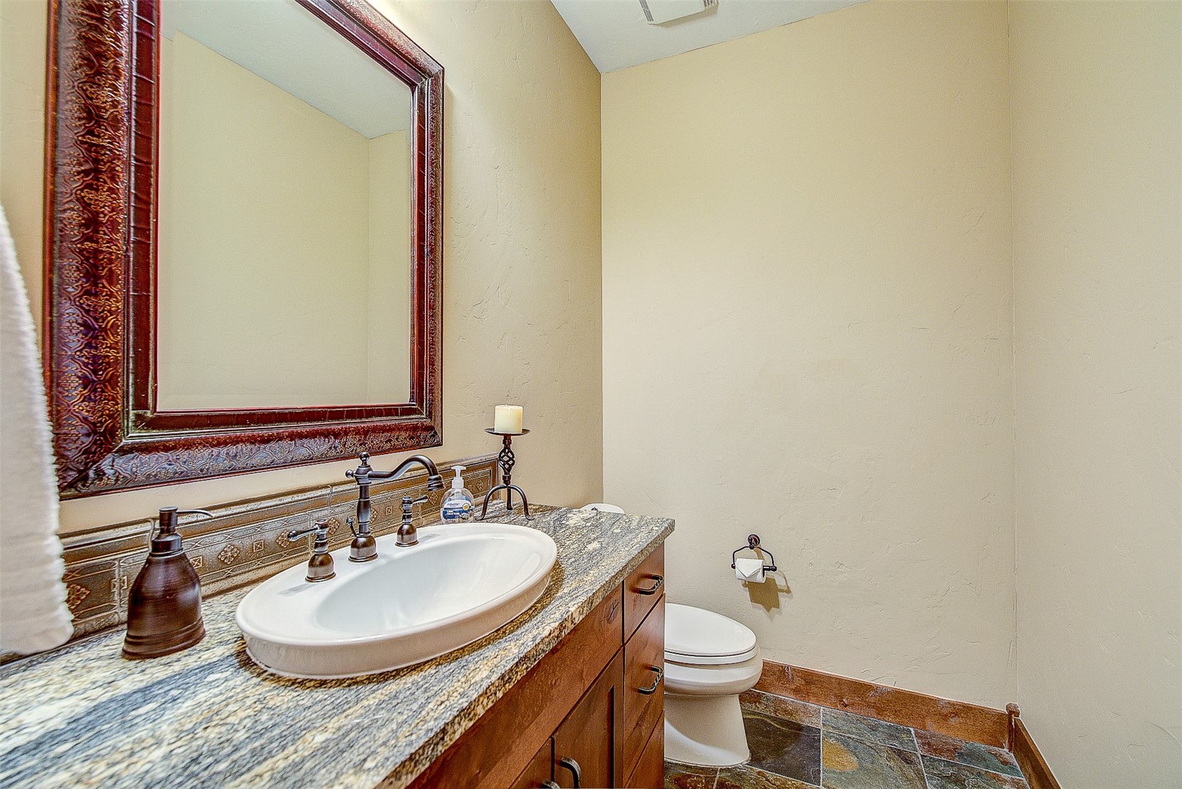59 Club House Road, Unit C Breckenridge, CO 80424 - Photo 35 of 50 Bathroom featuring stone tile floors, vanity, and a textured wall