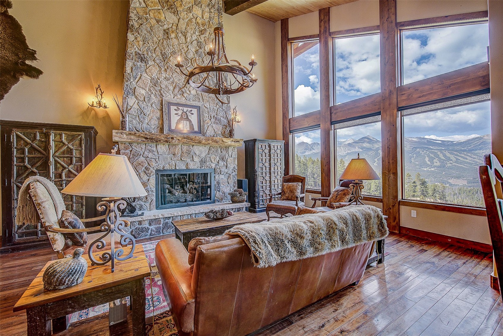 59 Club House Road, Unit C Breckenridge, CO 80424 - Photo 4 of 50 Living room featuring a high ceiling, a fireplace, hardwood / wood-style flooring, a chandelier, and a mountain view