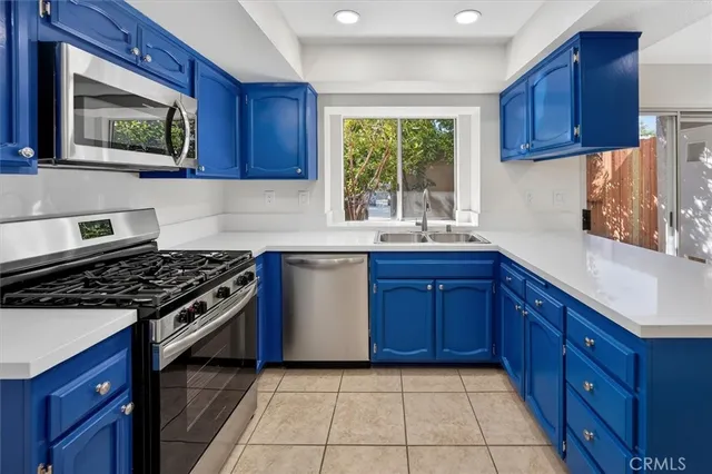 a kitchen with a stove a sink and a microwave