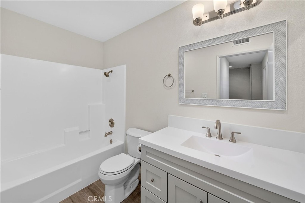14344 Foothill Boulevard, Unit 1004 Sylmar, CA 91342 - Photo 17 of 27 a bathroom with a sink a toilet and shower