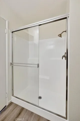 a bathroom with a glass shower door