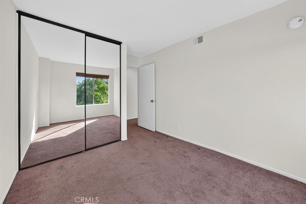14344 Foothill Boulevard, Unit 1004 Sylmar, CA 91342 - Photo 20 of 27 a view of an empty room with a window