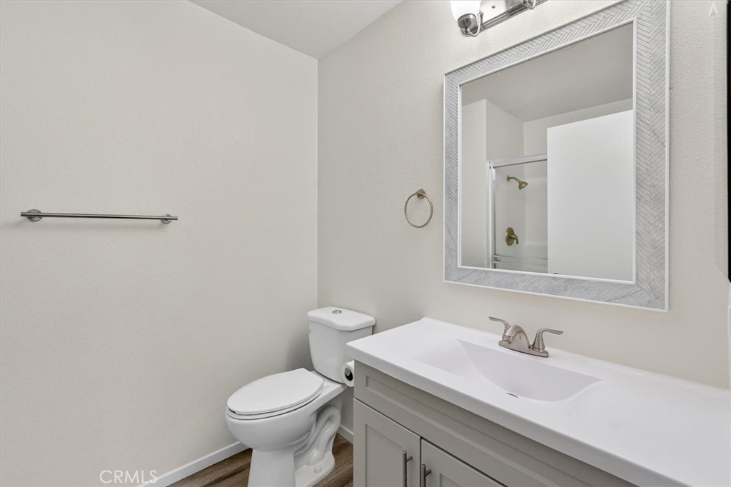 14344 Foothill Boulevard, Unit 1004 Sylmar, CA 91342 - Photo 22 of 27 a bathroom with a sink a toilet and a mirror
