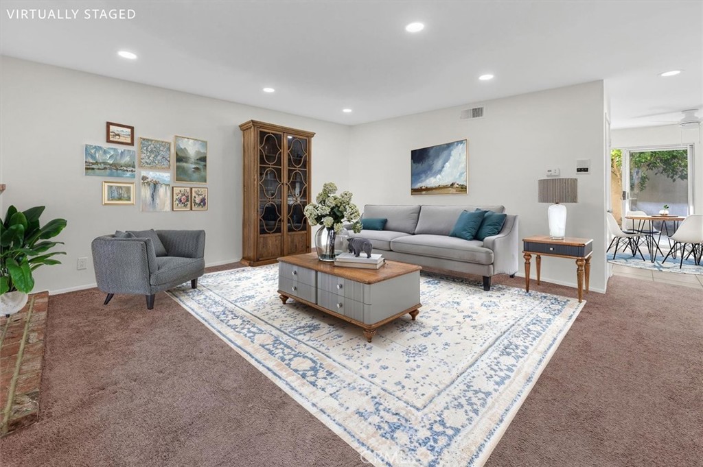 14344 Foothill Boulevard, Unit 1004 Sylmar, CA 91342 - Photo 6 of 27 a living room with furniture and a rug